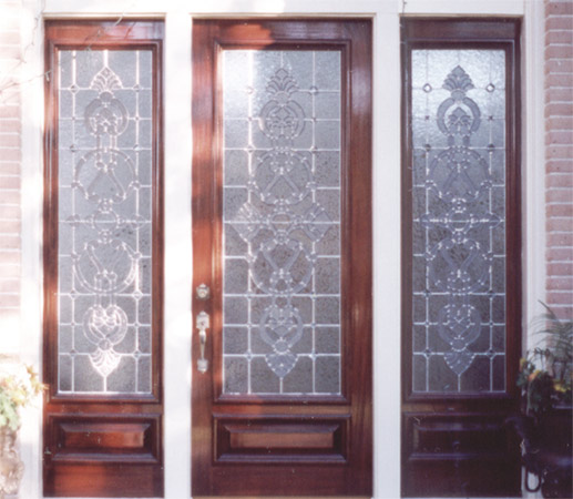 Custom entry with intricate designs in door and side light windows