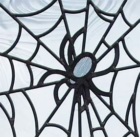 Closeup of custom leaded glass spider web window
