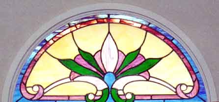 Victorian style stained and leaded glass arched window