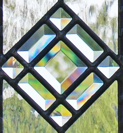 Closeup of custom leaded glass abstract transom window