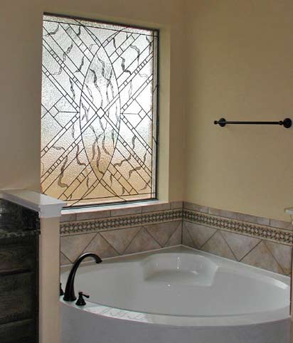 large leaded glass window over a garden tub