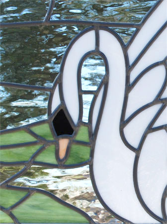 Closeup of custom stained and leaded glass small Swan window