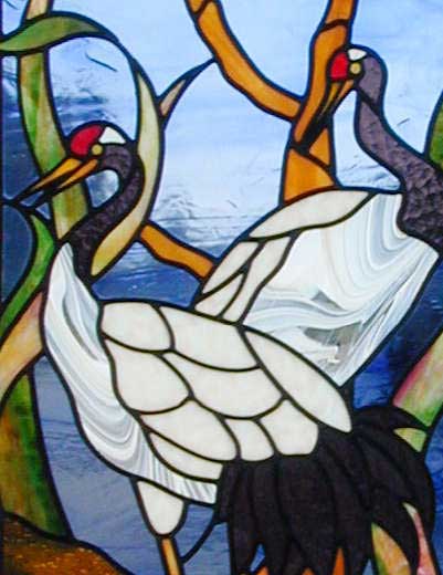Closeup of custom stained and leaded glass oriental cranes window.