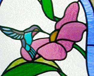 Closeup of custom hummingbird, flowers stained glass window