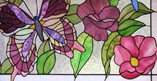 Closeup of stained and leaded glass butterflies and flowers window